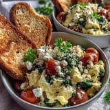 Golden scrambled eggs and sautéed spinach are topped with crumbled feta cheese in this savory Mediterranean-inspired Spinach and Feta Breakfast Bowl.
