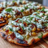 Spicy jalapeño crema drizzles over loaded Cinco de Mayo Street Corn Flatbread.