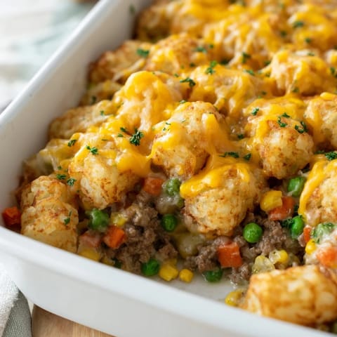 Golden brown, crispy tater tots cover a savory ground beef and vegetable filling in this Tater Tot Casserole.