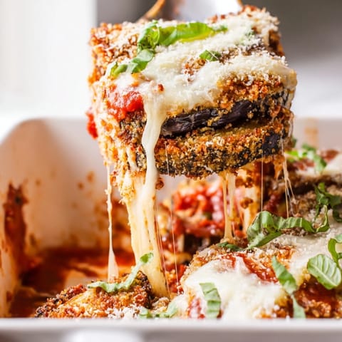 Thick eggplant rounds breaded and baked to perfection, layered with bubbling tomato sauce and Parmesan cheese.